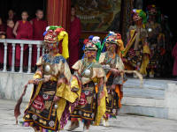 Dancers entering the dance area from the Gompa