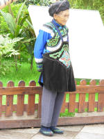 Old woman in traditional dress posing for a photo