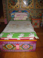 Bed in front of painted wall