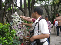 Money being stuck on a statue