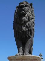 One of four lions guarding a bridge